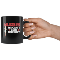 Nurses we can't cure stupidity black coffee mug