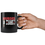 Nurses we can't cure stupidity black coffee mug