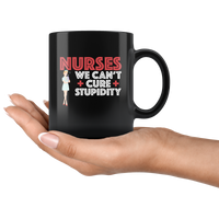 Nurses we can't cure stupidity black coffee mug