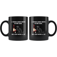 A Woman cannot survived on wine alone she needs a cat black coffee mug